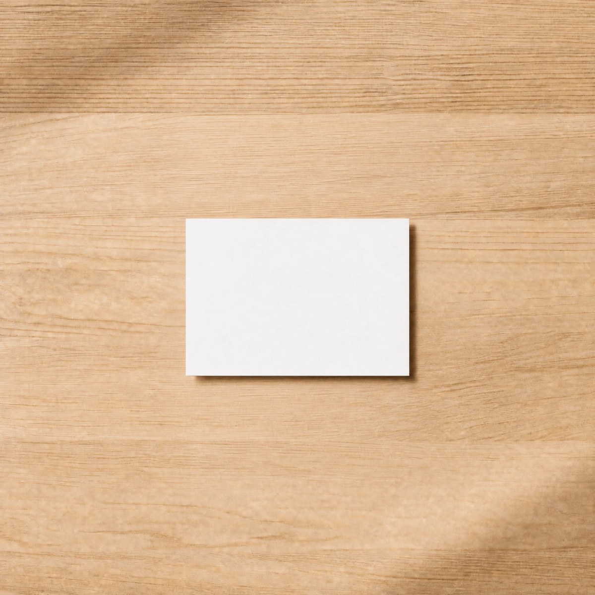 A landscape card lying on a wooden table